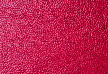 Textures red leather close-up abstract background.