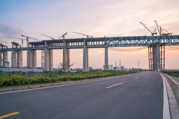 Yangtze River Bridge and asphalt road under construction in Suzhou, China