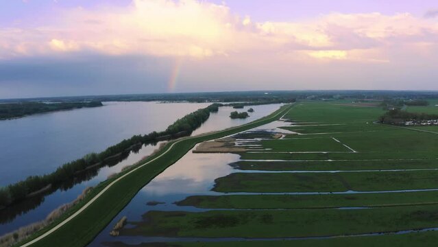 Incredible aerial drone view of flooded countryside dikes in Netherlands, sunset