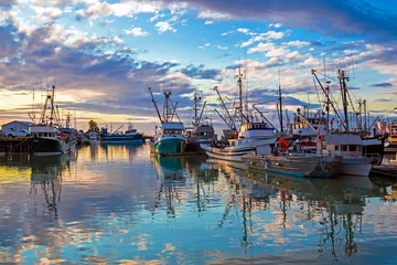Fotobehang   Fishing Boats in Marina and a cloudy sky. This marina is located in the Steveston area of Richmond. The fishing village formed in this place was the first settlement on the territory of  Richmond   © Alex Lyubar
