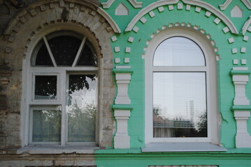 Two arched windows, old and new.