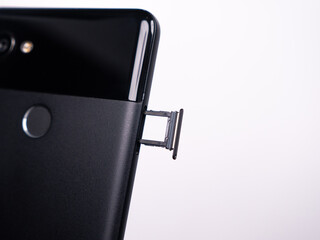 SIM tray for SIM card in smartphone close-up view on a white background