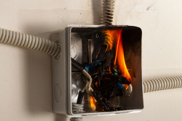 Burning wires in the electrical panel, short circuit and overload led to a fire