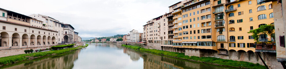Fototapeta na wymiar View at Arno river embankments and Ponte alla Grazie in Florence, Italy