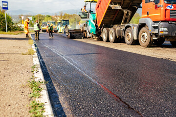 Laying a new asphalt on the road. Construction of the road