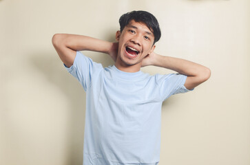 asian man in blue shirt very cheerful man on isolated background