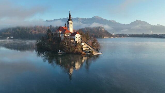 Lake Bled on a beautiful spring morning with mist and low clouds at sunrise. Lake Bled is located in Slovenia, near the Julian Alps. It's an Alpine jewel with a little island in the middle of the lake