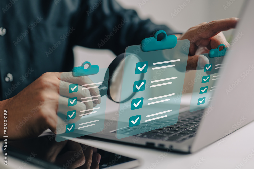 Poster Businessman use magnifying glass with a checklist on clipboard paper. Successfully complete business assignments.