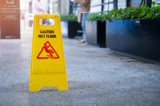 Sign showing warning of caution wet floor in office building