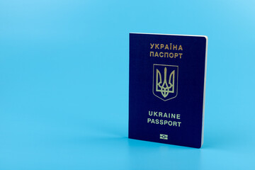 Ukrainian passport with a golden trident symbol on blue background. Biometric Ukraine passport id empty place for photo or text.