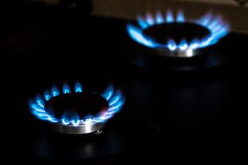 Closeup shot of blue fire from domestic kitchen stove top. Burning gas, gas stove burner. Gas...