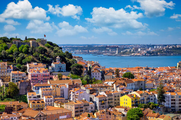 Fototapeta na wymiar The cityscape of Lisbon, Portugal, with Sao Jorge Castle and the red roofes of the Alfama district on a sunny day
