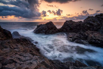 Magnificent colorful seascape with picturesque rocks in sunrise time