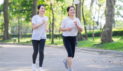 Image of Asian mother and daughter exercise at park - obrazy, fototapety, plakaty