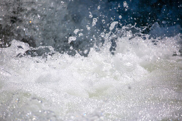 Drops of water, splashing and bubbling waterfall as a background. Foam party or laundry. The...