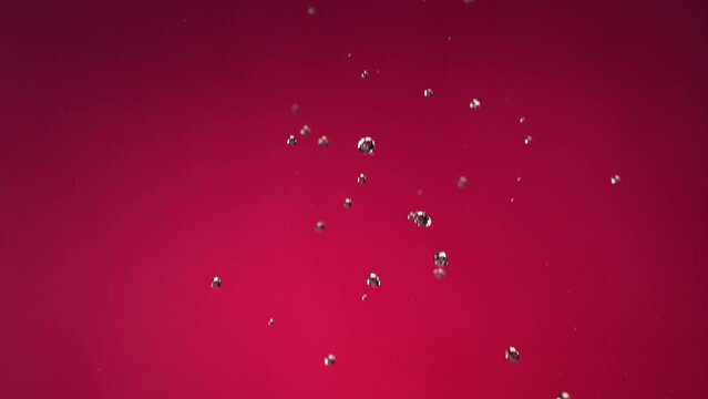 Flying of Pomegranate in Fuchsia Background in Slow Motion