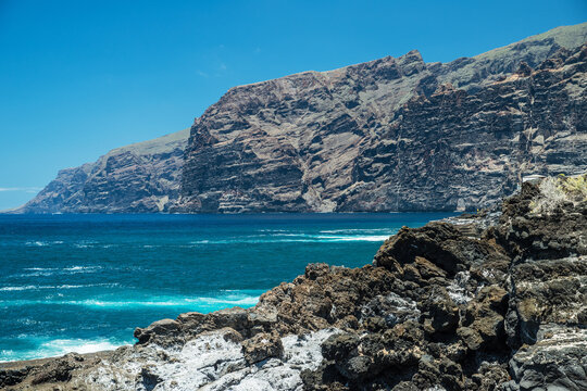 Jagged and dotted rocky coastline with amazing azure water of Tenerife Island.