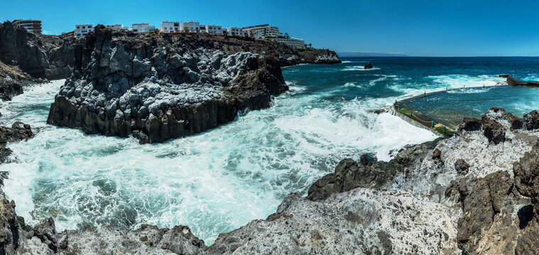 Jagged and dotted rocky coastline with amazing azure water of Tenerife Island.