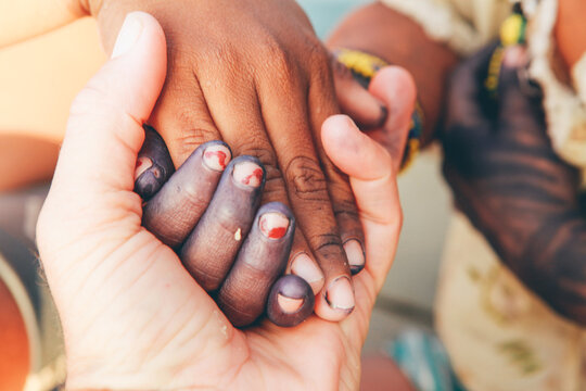 Multiracial people holding hands
