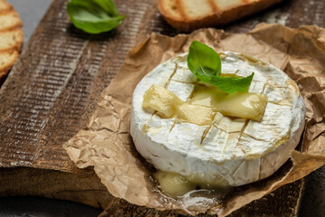 camembert cheese baked with with basil leaves and wine. banner, menu, recipe place for text, top view