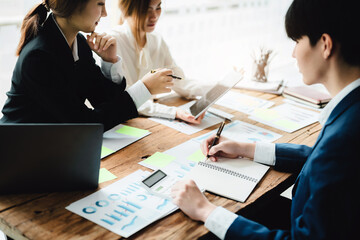 Brainstorming, Consulting, Data Analysis, Planning, Marketing and Accounting, Economist holding pen pointing to investment documents with partners on profit taking to compete with other companies.