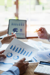 Business People Meeting to discuss and brainstorming the financial report paperwork in home office. Financial advisor teamwork and accounting concept.