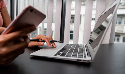 Work-at-home freelancers looking for job advice. woman checking email and playing with laptop  phone