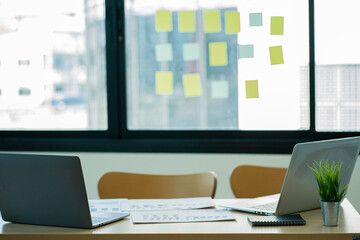 Fototapeta premium Financial graph document and laptop with a calculator, notebook on the desk, business research workplace.