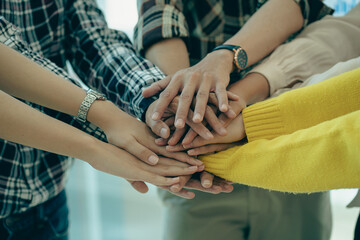 Young modern businesspeople shaking hands, feeling the power of working together. or celebrate the start of a new project in a modern office meeting. teamwork support concept
