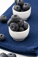 fresh, ripe, sweet blueberries, freshly picked berries in small portions inside white cups