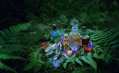 Magic witch bottles and mineral gemstones on dark forest natural background. Witchcraft, esoteric spiritual practice. pagan, Wiccan, Slavic traditions. ritual for Midsummer, Litha sabbat - obrazy, fototapety, plakaty