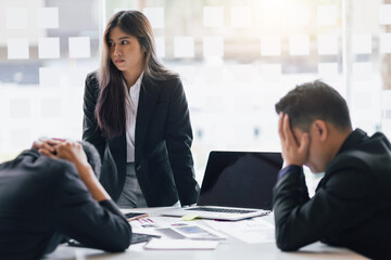 Business woman or boss in a meeting at work is seriously working. The boss is blaming the employee...