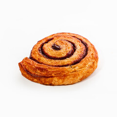 Crispy appetizing snail-bun with cinnamon puff, close-up. White background