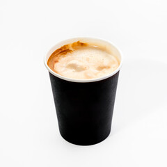 A paper cup with espresso coffee to take away. Close-up, on a white background