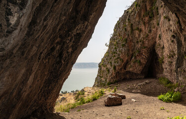 The exit  from the big cave in Mount Arbel, located on the coast of Lake Kinneret - the Sea of Galilee, near the city of Tiberias, in northern Israel - obrazy, fototapety, plakaty