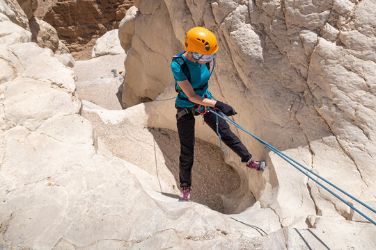An experienced athlete athlete descends with the equipment for snapping in the mountains of the Judean Desert near the Tamarim stream near Jerusalem in Israel
