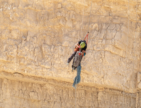 An experienced athlete athlete descends with the equipment for snapping in the mountains of the Judean Desert near the Tamarim stream near Jerusalem in Israel
