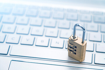 The lock is placed on the computer keyboard to symbolize information security and data interconnection