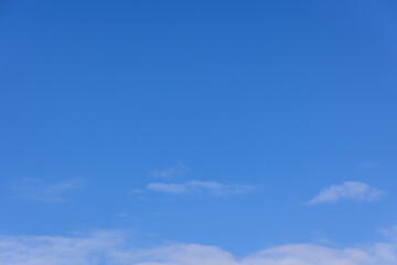 A blue sky with a few clouds