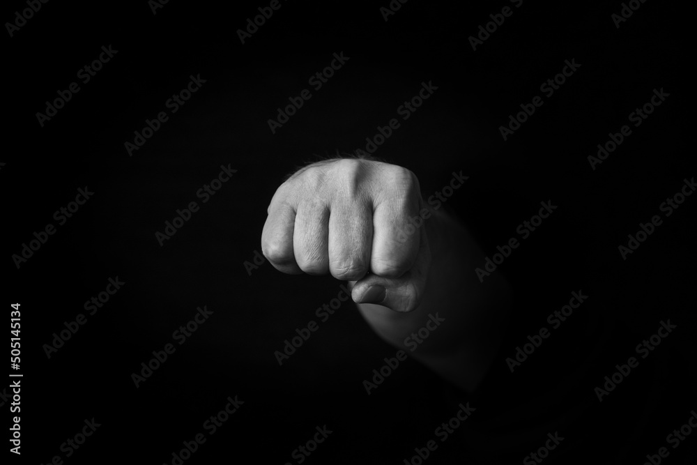 Wall mural Oncoming Fist emoji isolated on black background