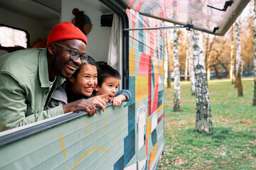 The multiracial family has fun in their motor home. - 505145140
