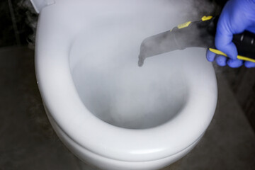 Cleaning and disinfection of the toilet with hot steam. Professional cleaning process