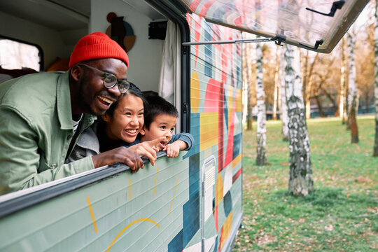 The multiracial family has fun in their motor home.
