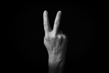 Reverse Victory Hand emoji isolated on black background - obrazy, fototapety, plakaty
