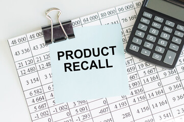 PRODUCT RECALL text on a blue card clipping to the report sheet. Business and finance concept