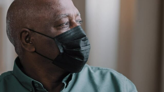 Portrait Old Lonely African Dominican Mature Man 60s Grandfather Mature Senior Male Sad Pensive Patient In Black Medical Mask At Home Indoors Looking Away Thinking Isolation Covid Coronavirus Pandemic