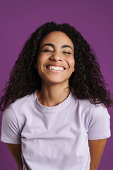 Young black woman with wavy hair smiling at camera