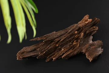 Foto op Plexiglas Close UpShot Of Sticks Of oudh On Black Background The Incense Chips Used By Burning It Or For Arabian Oud Oils Or Bakhoor  © mohamed