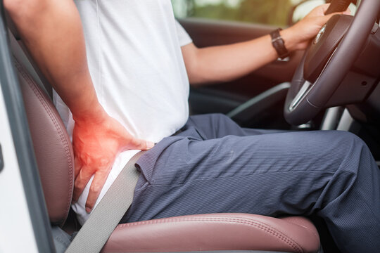 man with his back sprain while driving car long time, back body ache due to Piriformis Syndrome, Low Back Pain and Spinal Compression. Ergonomic and medical concept