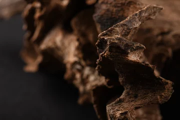 Fotobehang Close UpShot Of Sticks Of oudh On Black Background The Incense Chips Used By Burning It Or For Arabian Oud Oils Or Bakhoor  © mohamed